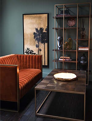 Luxury orange velvet sofa as a statement piece in an elegant living room
