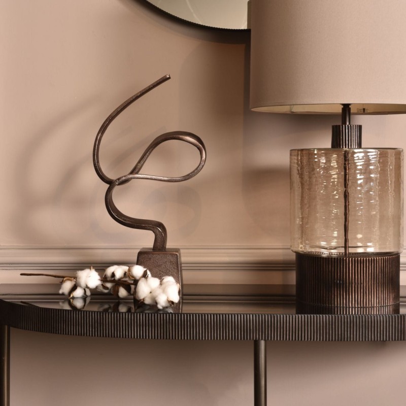 Brown aluminium sculpture on a plinth