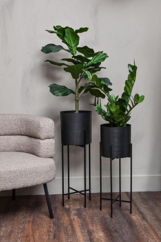 Tall black plant pots on metal stands