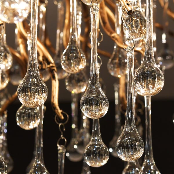 Innovation chandelier detail showing clear glass drops and gold frame
