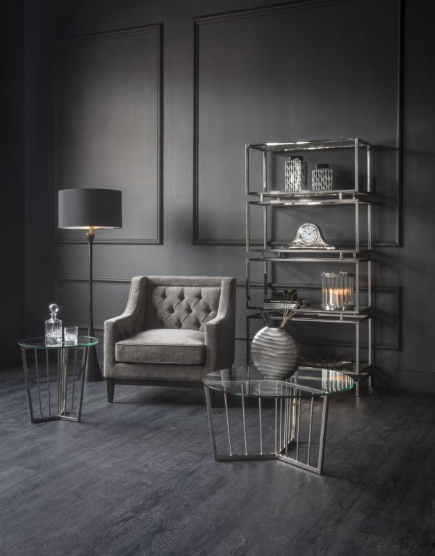 Cheval grey upholstered armchair with button-tufted back and dark wood frame