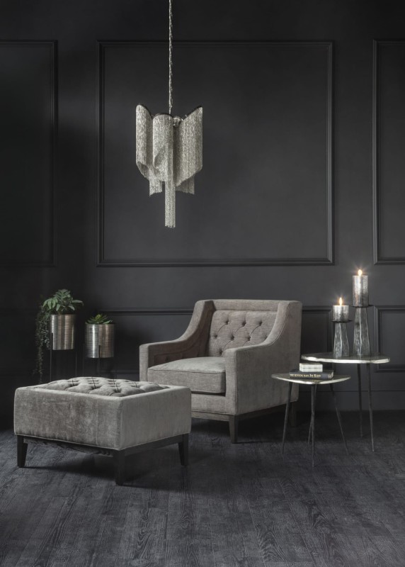 Cheval grey upholstered armchair with button-tufted back and dark wood frame