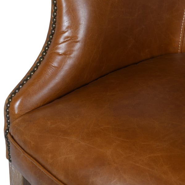 brown leather lounge chair with rubberwood legs
