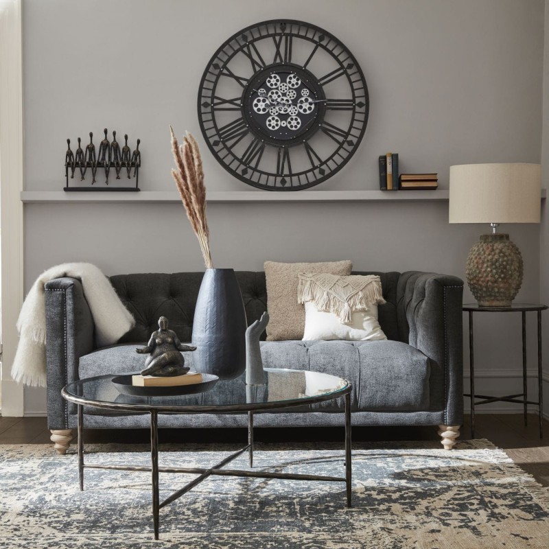 Large black iron wall clock with exposed cog mechanism for luxury interiors