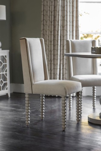 Robust Upholstered Ivory Dining Chair with Decorative Wooden Legs and Stitching