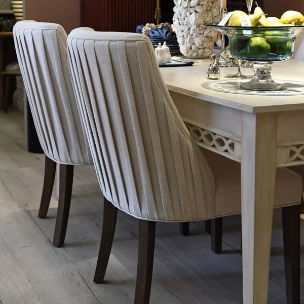 cream upholstered dining chair with decorative back detailing