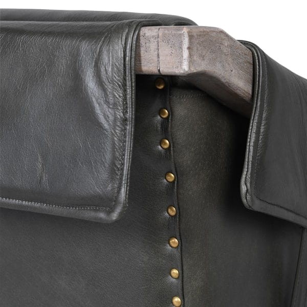 Dark grey vintage leather armchair with decorative buckle details