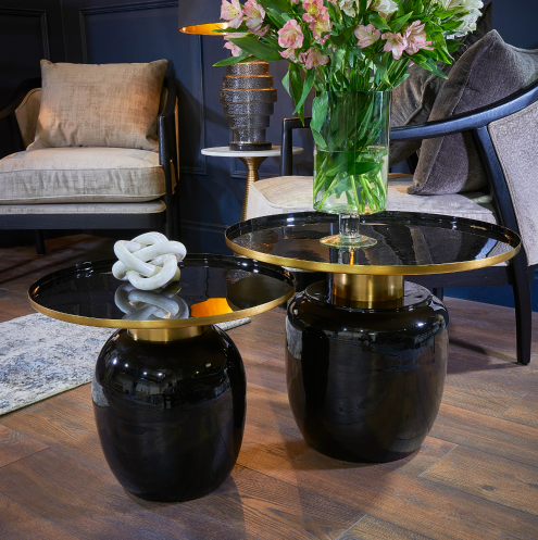 Two black and gold side tables in different heights