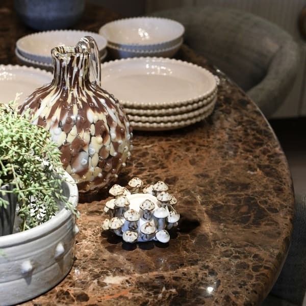 Oval dining table with a brown and black marble top