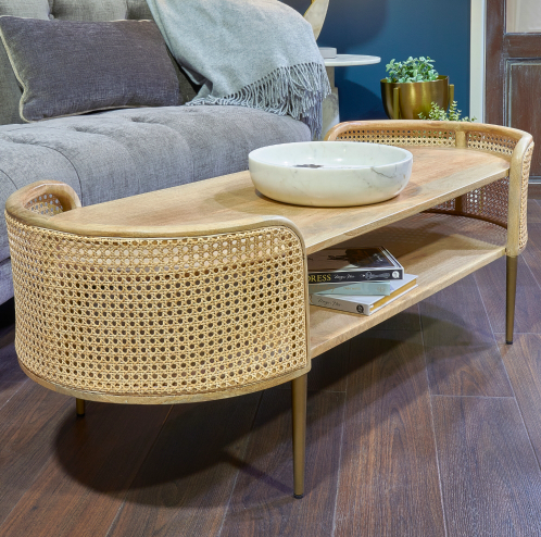 Oval wooden coffee table with rattan cane panels and gold legs