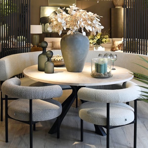 Round oak dining table with distressed wood top and black iron legs