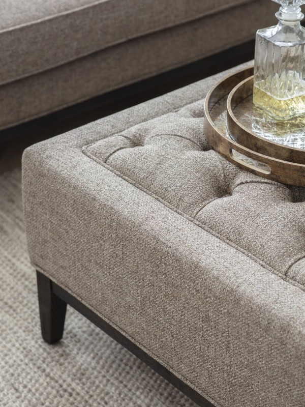 Large taupe ottoman on dark wooden legs