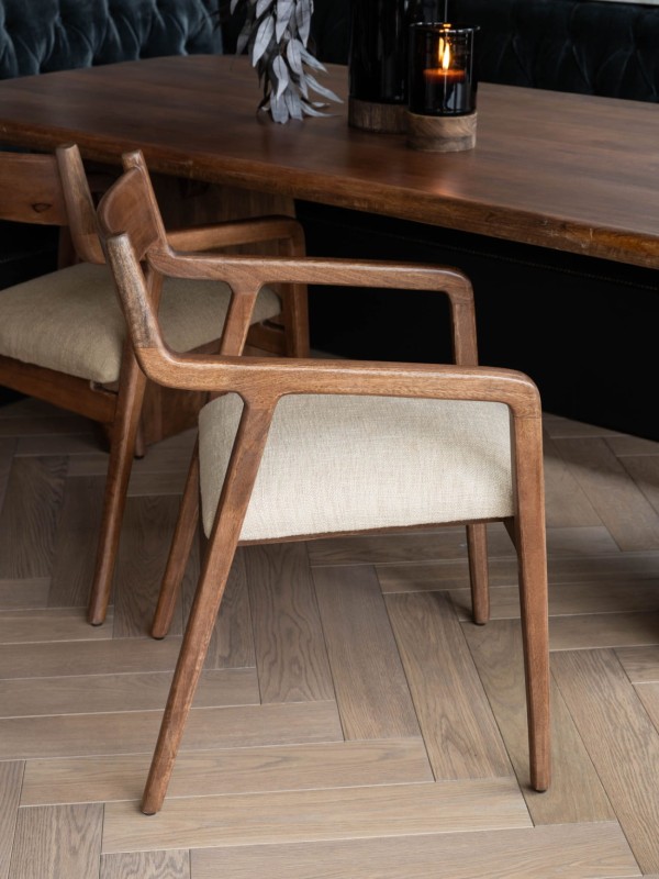 Beige upholstered dining chair with wooden armrests