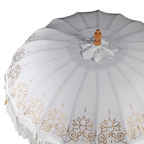 White outdoor parasol with tassels and wooden base