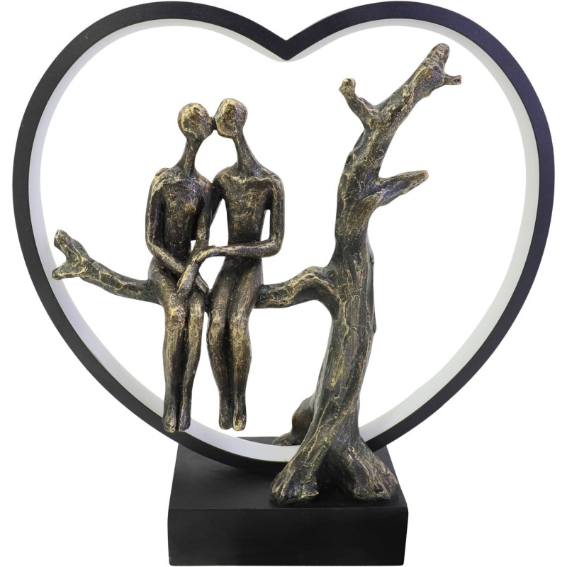 Warm LED decoration with two figures on a tree branch