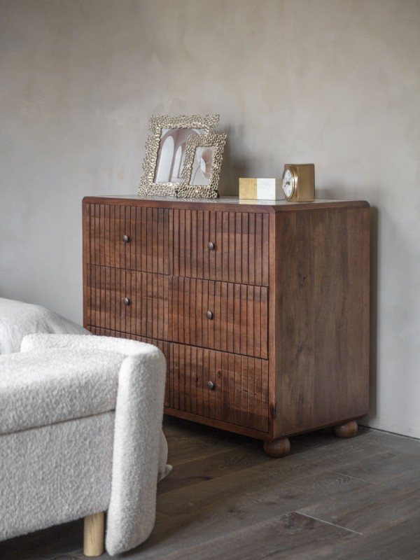 Dark wood chest with six fluted drawers