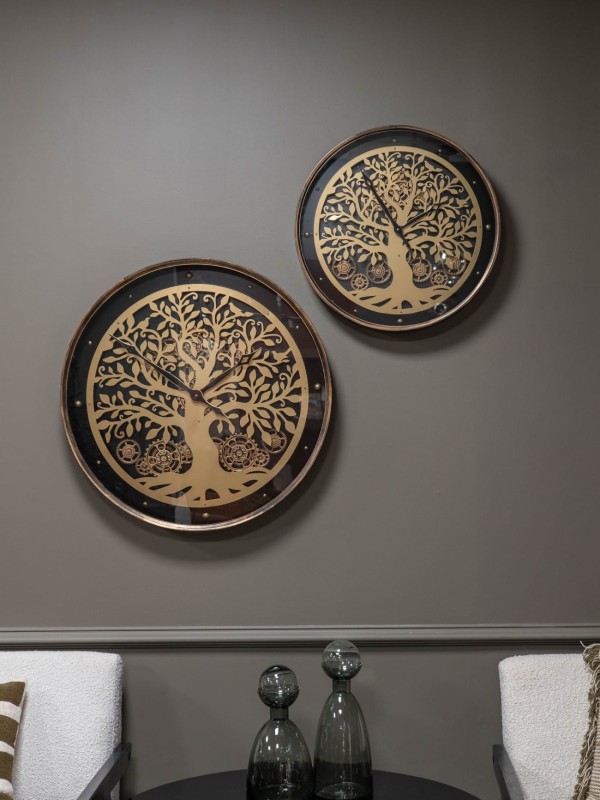 Black and gold wall clock with visible moving gears