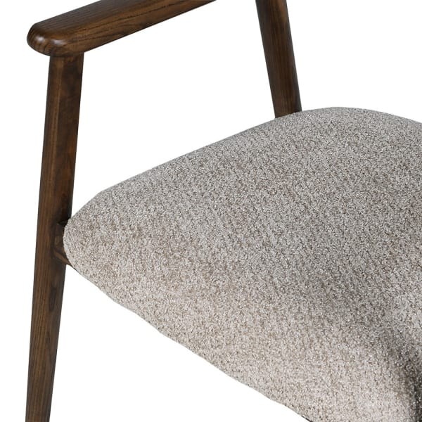 Beige polyester upholstery and dark wooden armrest on the Berlin dining chair
