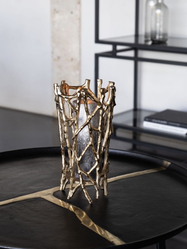 Sculptural gold candle holder with openwork design