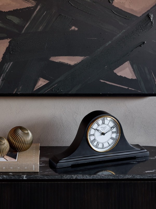 Black table clock with a white Roman numeral dial