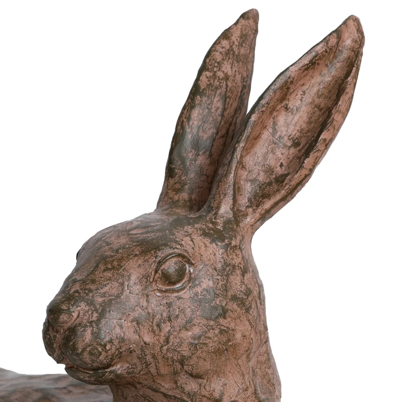 Decorative hare sculpture on a wooden sideboard