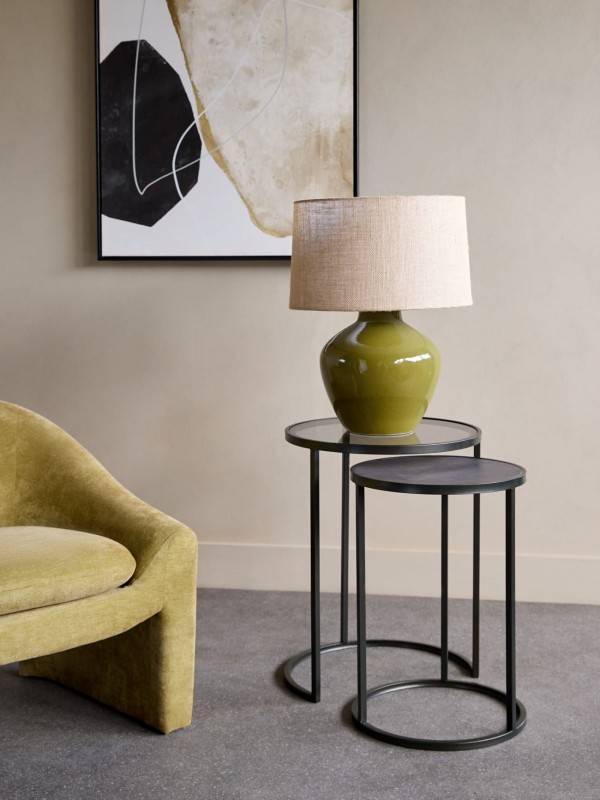 Round black side tables made from glass and iron