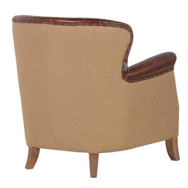 Classic brown leather armchair with wooden legs in a traditional style