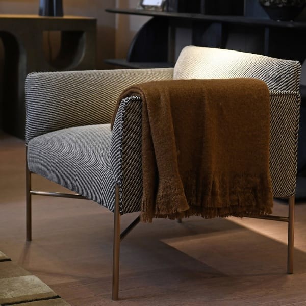Devon modern armchair in black and white upholstery with gold metal legs