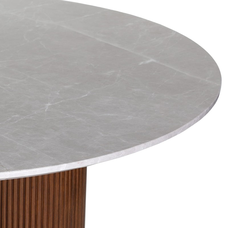 The Bremner round dining table features a marble top and a solid wooden base. With a 150 cm diameter, it is a luxury dining table ideal for elegant dining rooms and modern interiors.