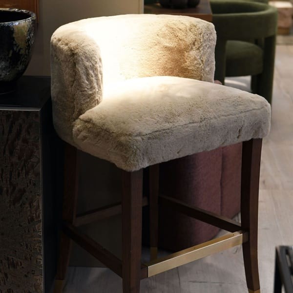 Lyall bar stool with faux shearling upholstery and an oak base. A stylish and comfortable bar stool for kitchen islands and modern interiors.