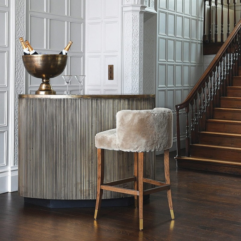 Lyall bar stool with faux shearling upholstery and an oak base. A stylish and comfortable bar stool for kitchen islands and modern interiors.
