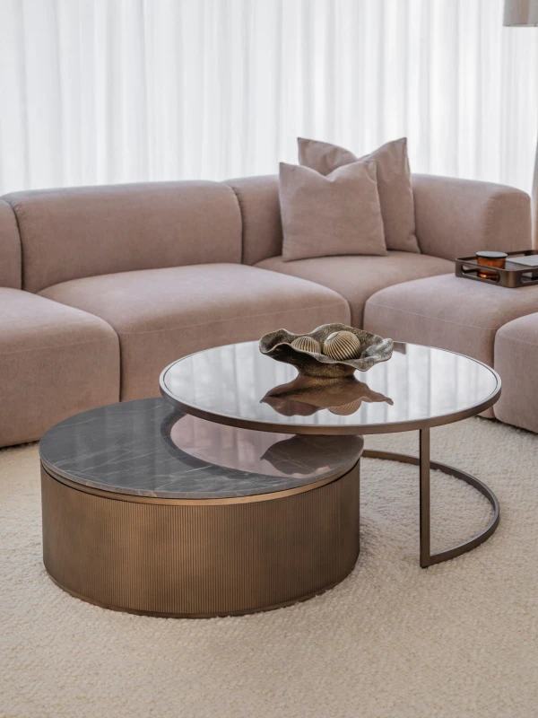 Primrose Royal nesting coffee tables beside a sofa in an elegant living room