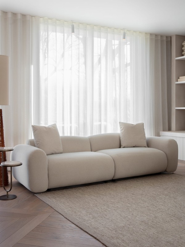 Brompton cream curved sofa styled in a contemporary living room