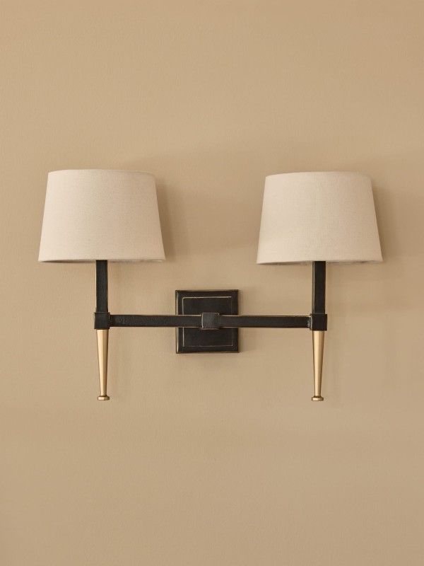 Stella wall light with two arms in black and gold, featuring two linen shades.