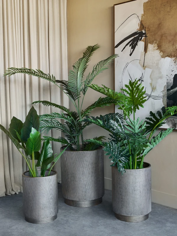 Set of three Primrose iron planters in antique gold, 60 cm tall. Stylish decorative planters for indoor and outdoor spaces with a timeless look.