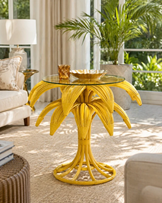 Yellow rattan palm side table with round glass top for boho interior