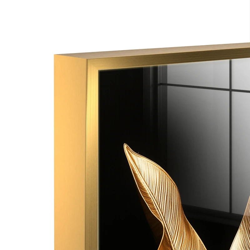 Black and gold botanical glass wall art in a gold frame
