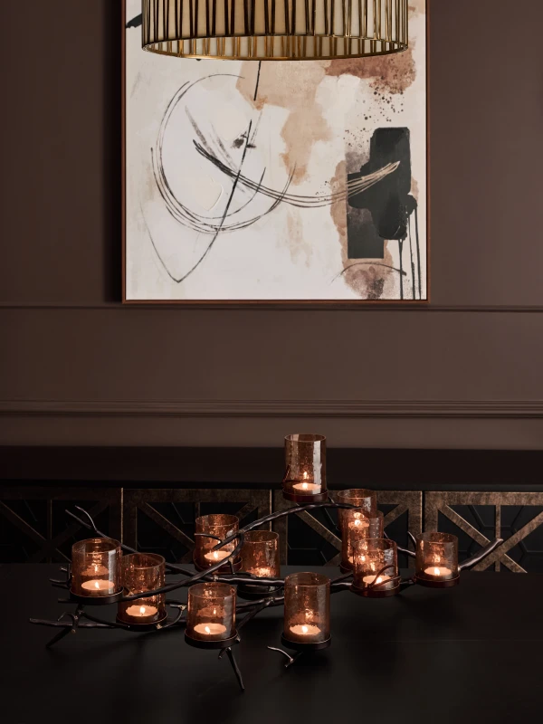 Sculptural bronze candle holder with eleven textured glass votives