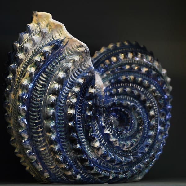 Large shell shaped ceramic vase in blue and white