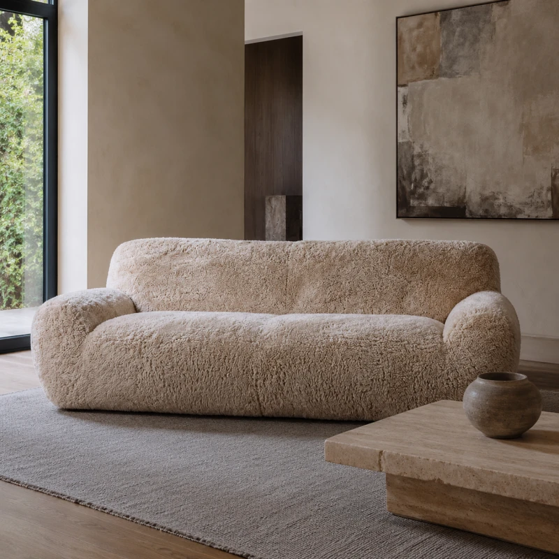 Lyall large curved sofa with warm beige faux sheepskin upholstery