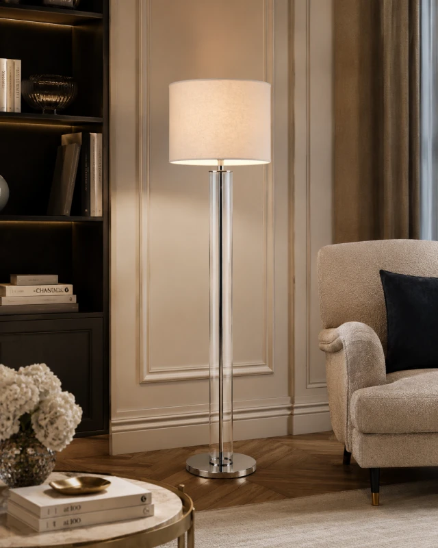 Clear floor lamp with a cream linen shade and silver base