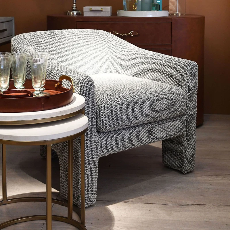 Contemporary Hill armchair with a three-leg design