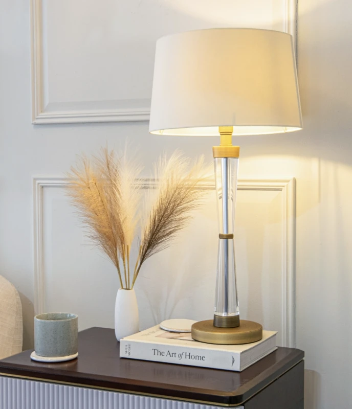 Clear glass table lamp with dark gold-toned details