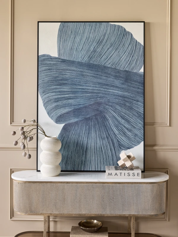 Blue abstract canvas displayed above a console table