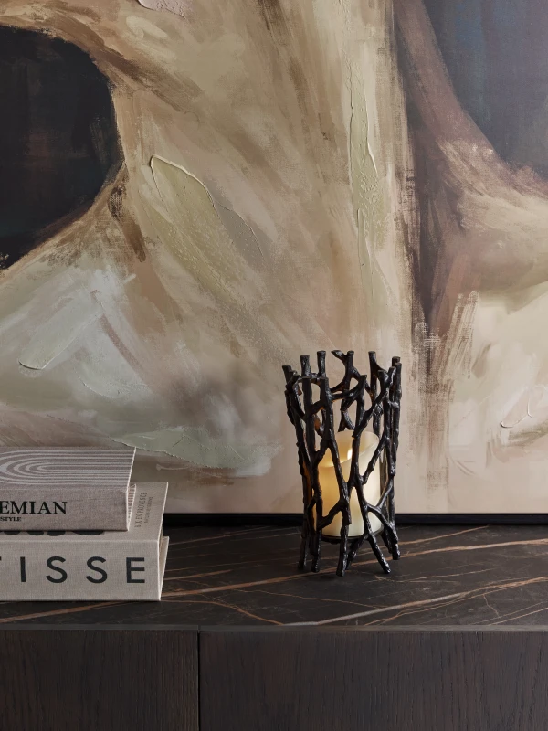 Sculptural black candle holder with openwork design