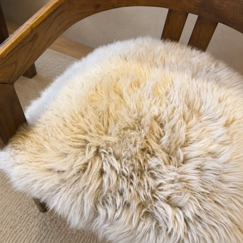 Cream sheepskin dining chair with brown oak arms