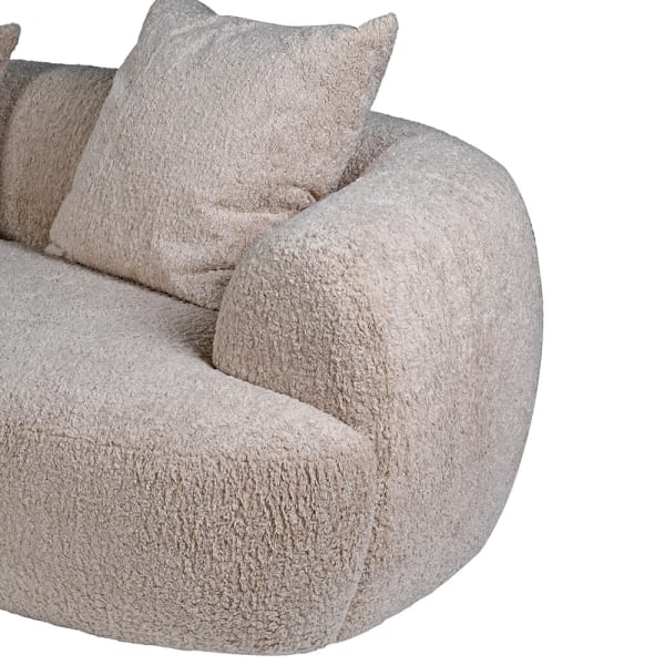 Close-up of cream bouclé upholstery and rounded arm on the Ava sofa