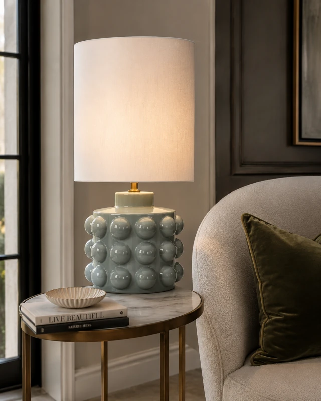 Large celadon table lamp with linen shade in an elegant living room