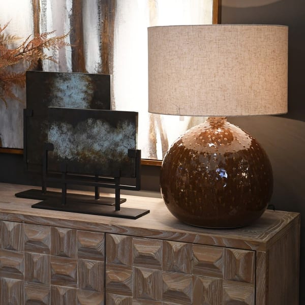 Bronze Bubble ceramic table lamp styled on a wooden sideboard in a warm neutral interior
