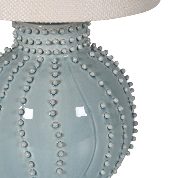 Close-up of glazed pale blue ceramic base with raised beaded detail on Regent Blue table lamp